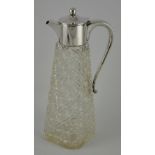 A George V silver mounted claret jug with hobnail cut glass body,