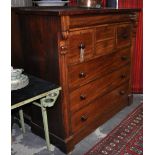 A mid Victorian mahogany chest with concealed drawer over an arrangement of four short and three