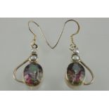 A pair of silver drop earrings set with topaz and pearls