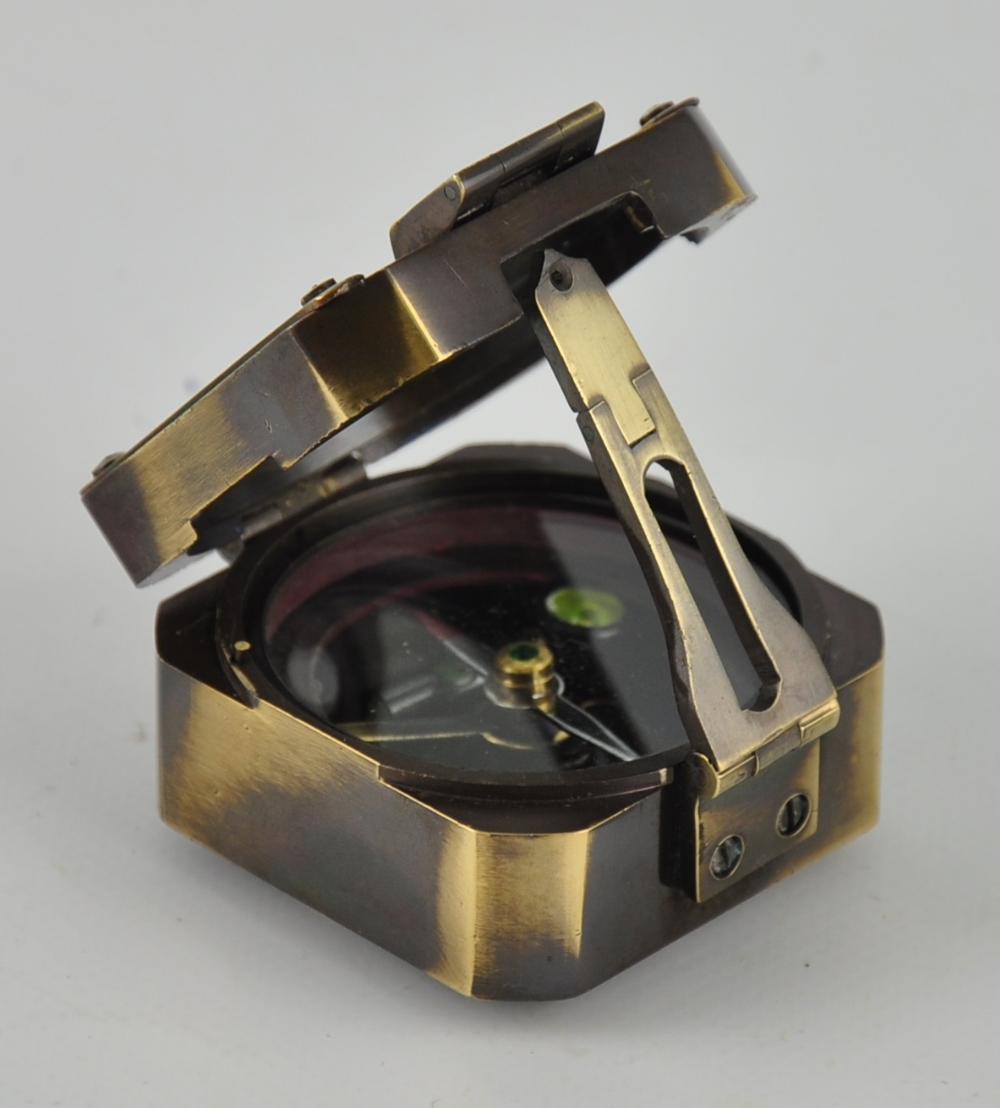 A brass military compass with crown