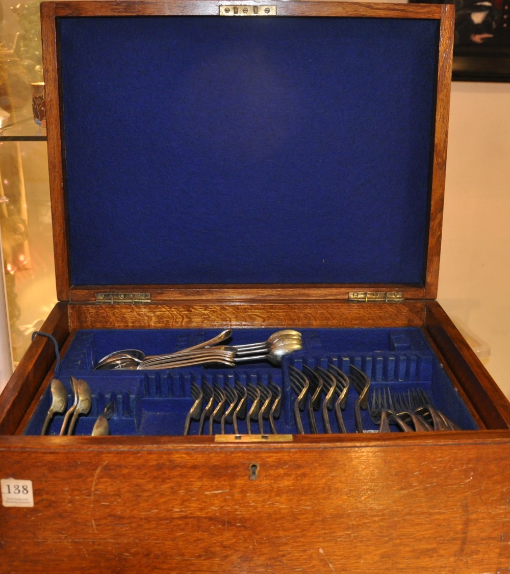 An Edwardian oak cased fifty piece silver plated part canteen of cutlery together with sundry other