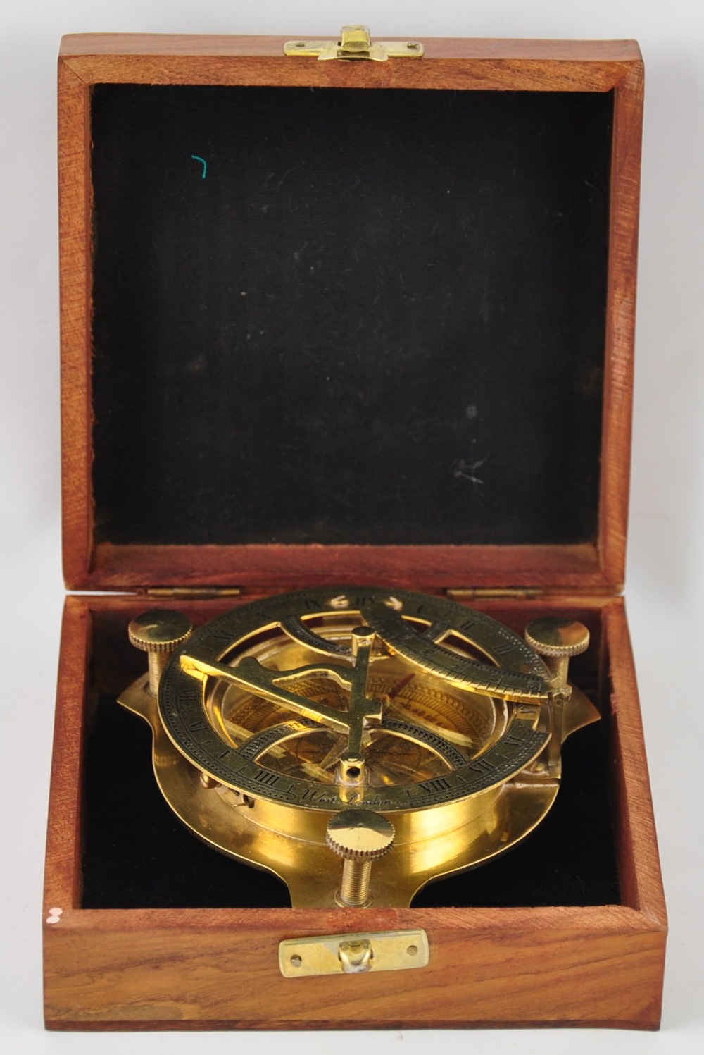 A large brass compass with astronomical instrument in a wooden box
