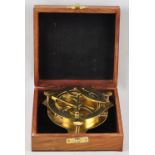 A large brass compass with astronomical instrument in a wooden box