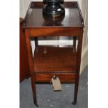 A George III mahogany two tier wash stand with three quarter galleried top,