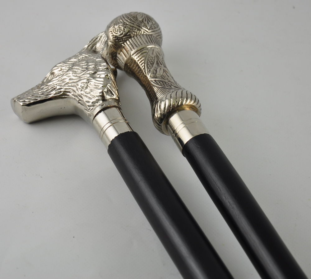 Two black walking sticks with silvered tops