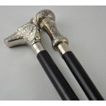 Two black walking sticks with silvered tops