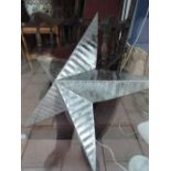 A large decorative silver star wall plaque
