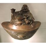 A Chinese bronze of a seated Buddha on ingot cast plinth