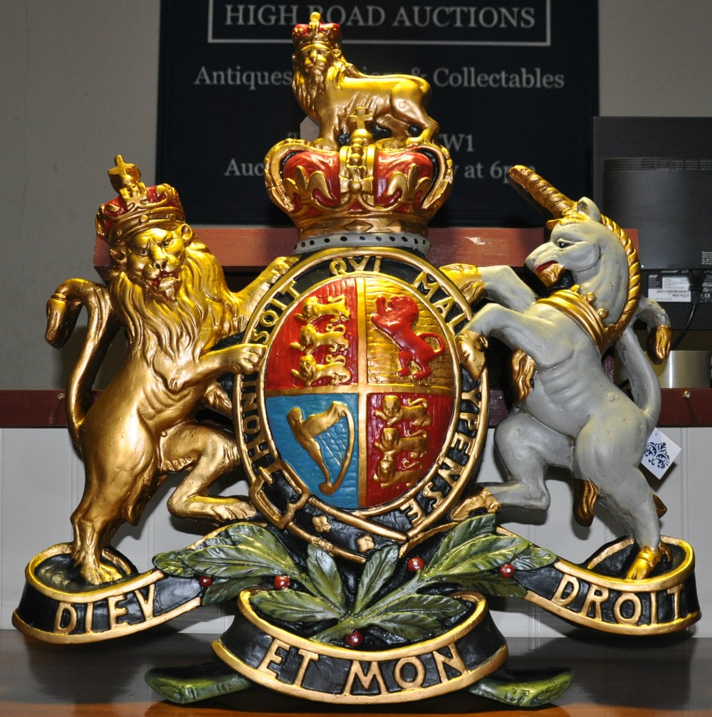 A large painted composition coat of arms wall plaque