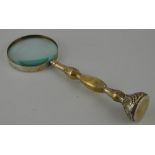 A large brass table magnifying,