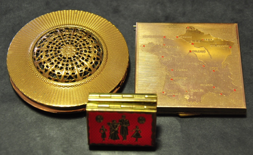 A vintage gilt metal circular powder compact, together with a compact showing a map of France,