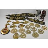 Ten horse brasses on three leather harnesses, together with thirteen further horse brasses,
