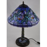 A Tiffany style blue glass table lamp, the leaded shade decorated with dragonflies,