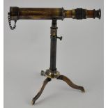 An all brass telescope with a stand and cover