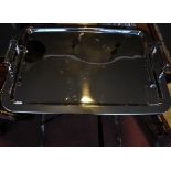 A chrome dining tray on a large X-framed stand,