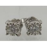 An 18 carat white gold and solitaire diamond stud earrings, the stones of approx. 0.50 carats
