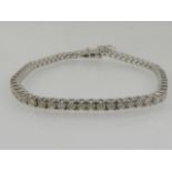 An 18 carat white gold and diamond line bracelet, the diamonds of approx. 3.10 carats combined.