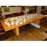 A large satin birch boardroom table, the rectangular top with ebonised banding and raised on twin