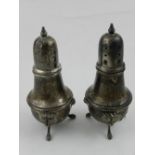 A pair of Poole white metal pepperettes, stamped Sterling.