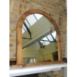 A large arched overmantel mirror within a pine frame, H. 101