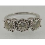 An 18 carat white gold and diamond ring, set three stones of approx. 1.0 carat combined.