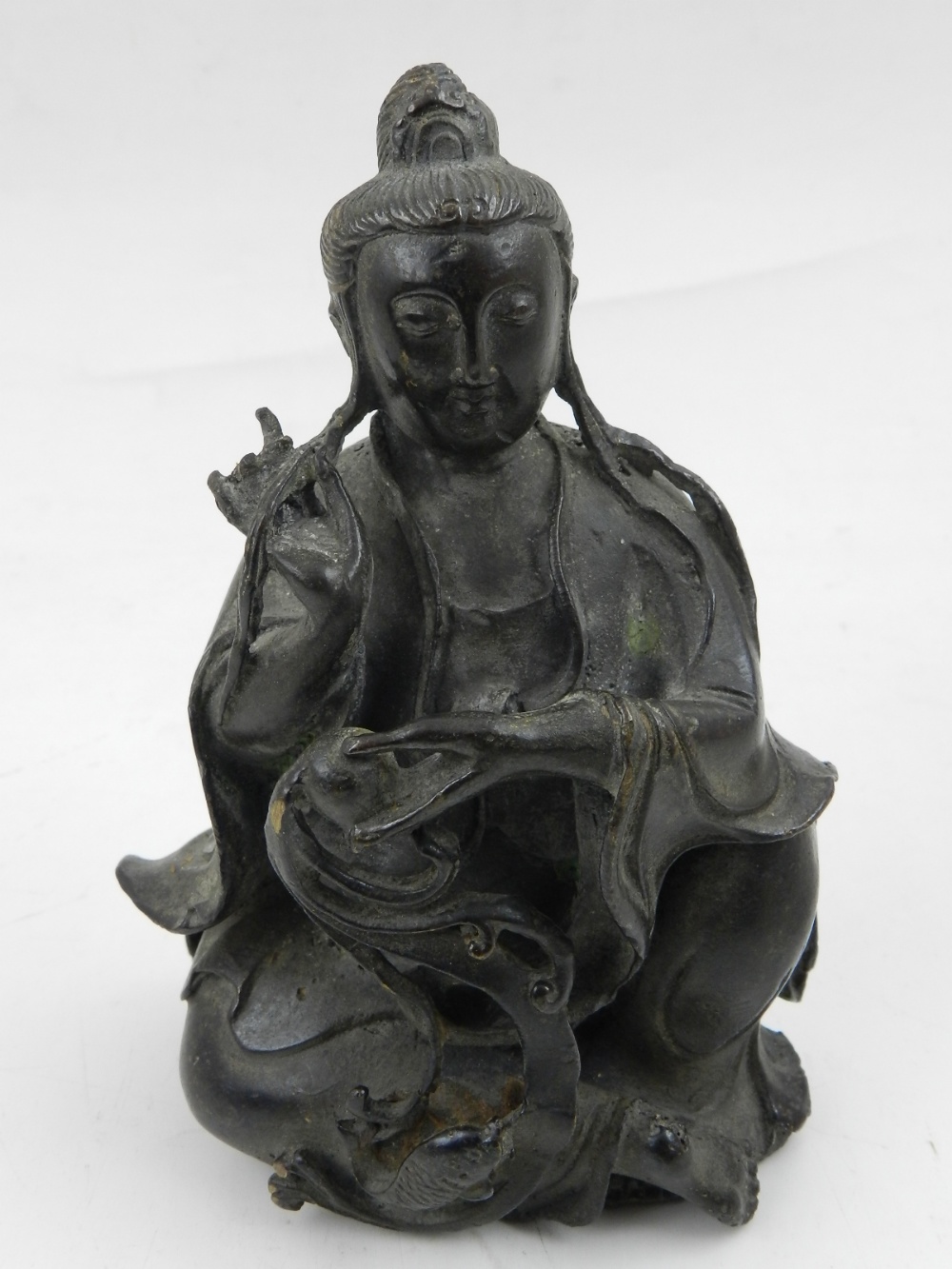 A Chinese bronze seated figure of Guanyin. H: 13cm