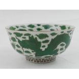 A Chinese porcelain rice bowl, decorated in green with dragons chasing flaming pearls. H: 6cm