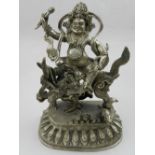 A white metal study of a Hindu deity seated on a kylin, raised on a lotus base. H: 18cm