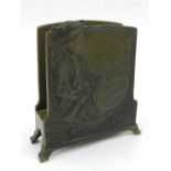 An early 20th Century German Art Nouveau bronze stationary holder embossed with a sporting