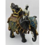 A cold painted bronze in the form of an Arab man riding an elephant,