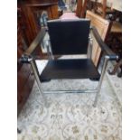 In the manner of Basculant, a black leather and chrome elbow chair,