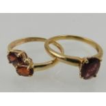 A 9 carat yellow gold and single stone garnet ring,