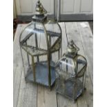 A graduated pair of Turkish style gilt metal square lanterns on paw feet,