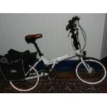 A Wisper 806 Albino electric folding frame bicycle with panniers, charging unit,