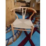 A Contemporary beech bow chair with wishbone slat and seagrass seat