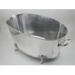 A silver plated twin-handled oval champagne bath, raised on four paw feet.