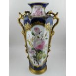 A 19th century French twin handled vase, decorated with floral vignettes to front and back on a gilt