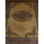 A Turkish honey ground rug, decorated with circular scrolling medallion to centre,