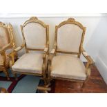 A pair of Louis XVI style chairs with open arms and turned and reeded legs,