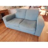 An Oliver Bonas two seater sofa upholstered in patterned aquamarine fabric