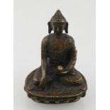 A small Tibetan bronze study of Buddha, seated on a lotus base. H.
