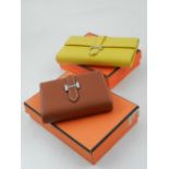 A designer leather purse, together with another similar, (2).