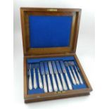 A boxed white metal six piece cutlery set, overall with foliate design, bears purity marks to