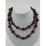 A garnet beaded cluster necklace, the yellow metal clasp stamped 9ct.