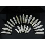 Twenty three silver hallmarked folding fruit knives all with mother of pearl scales, variously