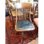 A 1920's beech lathe back office chair on quadruple downswept base