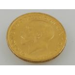 A George V gold sovereign,