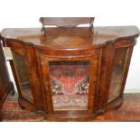 A Victorian walnut credenza, of serpentine form with mirrored panel doors, on a plinth base, W.