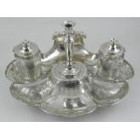 A Victorian solid silver desk stand, London 1856, the stand of shell form, comprising two silver