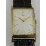 A gentleman's Universal wristwatch, the rectangular silvered dial marked baton markers, manual wind,